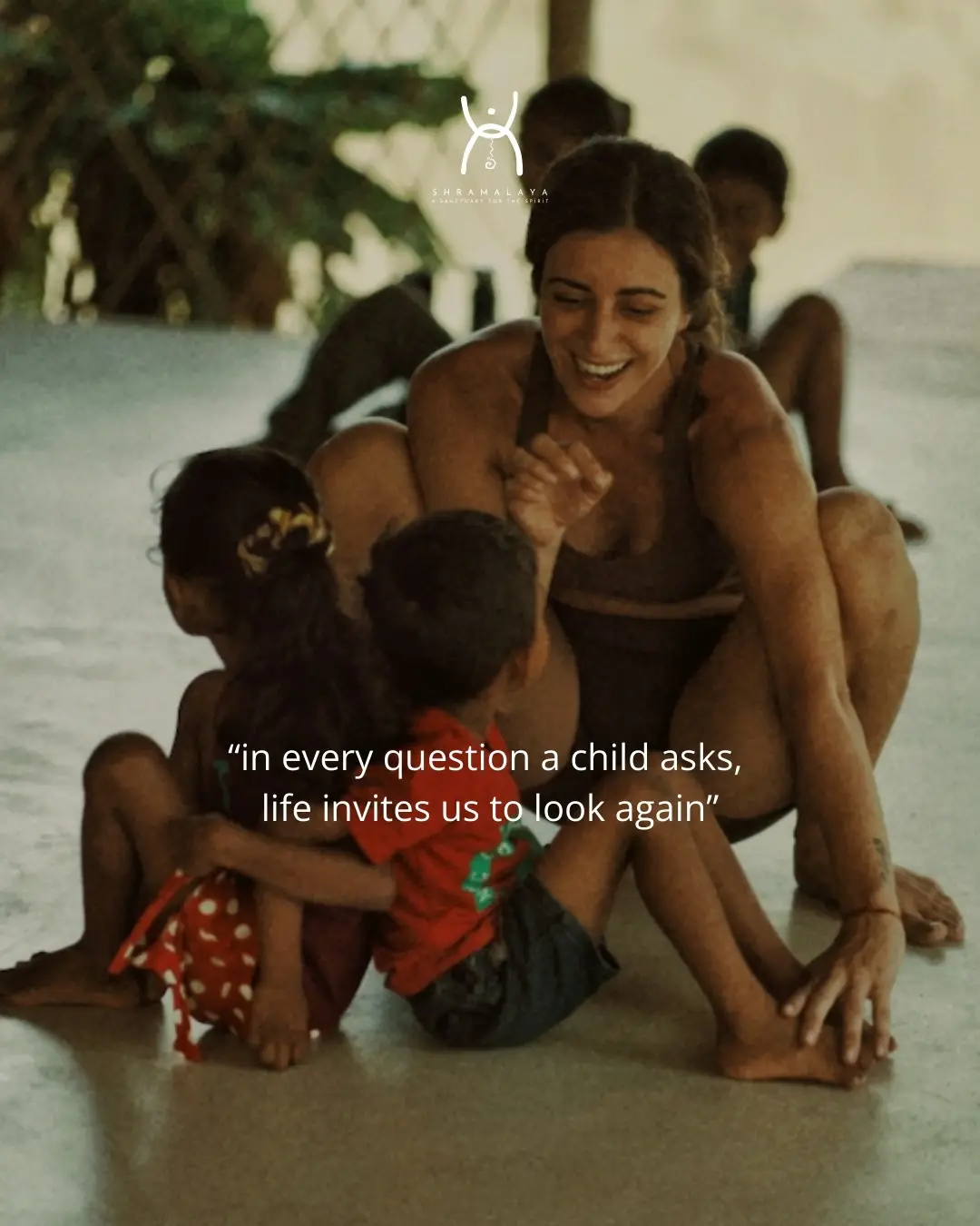 A teacher playing with children from the village at the shala